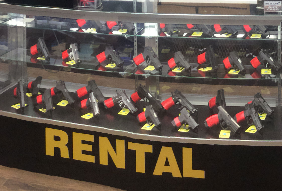 Close-up of RTSP Range Rental Firearms with TUFF1 Range Officer Red Grips