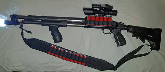 Mossberg Maverick 88 with 18.5 defense barrel, Trinity Supply 6 position tactical stock with pistol grip and Death Grip by TUFF1,Tac Star side saddle with rail mount, Vector optics 2.5-10x40 scope with green high visibility laser and red dot reflex sight combo, Tac Star tactical pistol grip forend with Death Grip by TUFF1, Polymer heat shield by John Masen, Iprotec barrel clamp with 7w 600lm Cree 5 mode flashlight and Ace Case 10 shot bandolier.